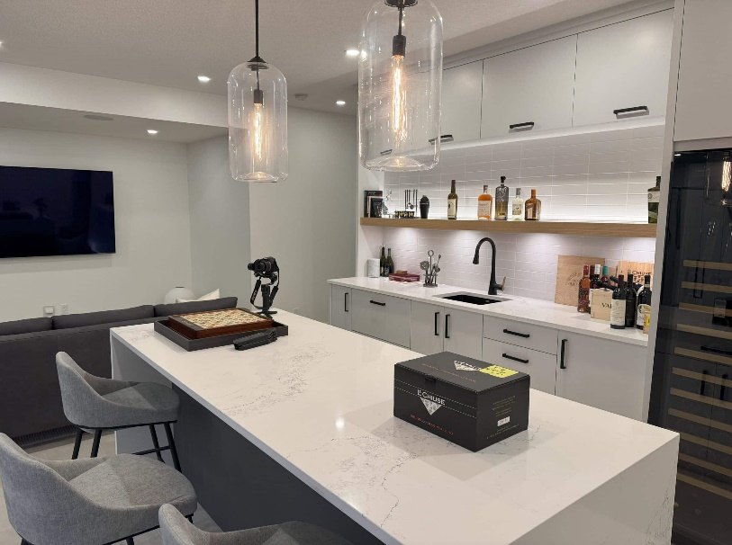 Kitchen with a glazed wine wall and a wall-mounted television