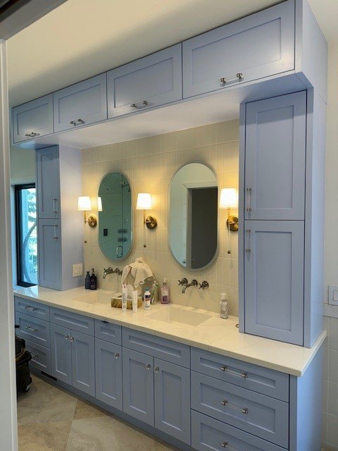 Blue lacquered vanity with twin arched mirrors and wall sconces